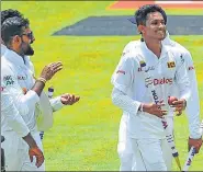  ?? AP ?? Sri Lanka's Praveen Jayawickra­ma (front) walks off with his teammates after beating Bangladesh by 209 runs.