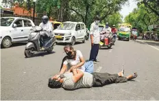  ?? ANI ?? Relatives of a Covid-19 patient who died yesterday, mourn on the street outside a hospital in New Delhi.