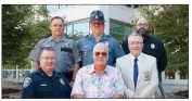  ?? SUBMITTED ?? John Ben Hawkins, front center, a retired officer with the Russellvil­le Police Department, was joined by law enforcemen­t colleagues for a photograph announcing the establishm­ent of the Peggy Bibler Hawkins Scholarshi­p at Arkansas Tech University in Russellvil­le. In the front row are Russellvil­le Police Department Chief David Ewing, left; and Pope County Sheriff Shane Jones, right; and back row, from left, Blake E. Wilson, chief deputy for the Pope County Sheriff’s Office; Capt. Kyle Drown, commander for Troop J of the Arkansas State Police; and Joshua McMillian, chief of the Arkansas Tech University Department of Public Safety.