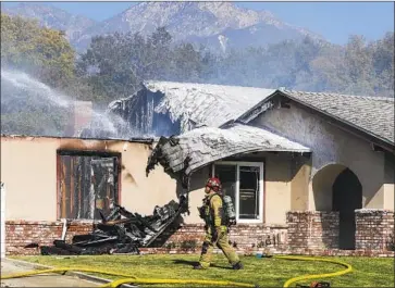  ?? Photograph­s by Irfan Khan Los Angeles Times ?? A PLANE CRASH and resulting fire collapsed the roof over part of an Upland home. Thursday’s wreck of a Cirrus SR-22 was at least the third of an aircraft near Cable Airport this year. The cause is not yet known.