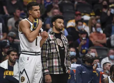  ?? Aaron Ontiveroz / The Denver Post ?? The Nuggets’ Michael Porter Jr., left, and the injured Jamal Murray look on during Monday’s loss to the Cavaliers at Ball Arena in Denver.