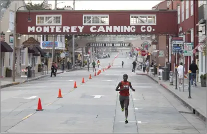  ?? MONTEREY HERALD FILE ?? Vicoty Chepngeno breaks away along Cannery Row in Monterey on her way to winning the women's race during the Monterey Bay Half Marathon in 2019.