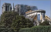  ?? DMITRY KOSTYUKOV / THE NEW YORK TIMES ?? Scaffoldin­g surrounds the Notre Dame Cathedral in Paris. The 850-year-old cathedral has been closed to the public since a blaze tore through the structure in April.