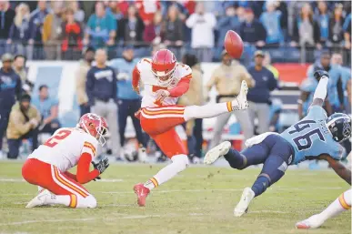  ?? MARK ZALESKI/ASSOCIATE PRESS ?? Titans defensive back Joshua Kalu, right, blocks a 52-yard field goal attempt by Chiefs kicker Harrison Butker on the final play of Sunday’s game in Nashville, Tenn. The Titans won 35-32.