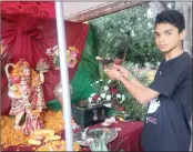  ??  ?? ABOVE: Ariana Soorujlall places her offerings at the temple. RIGHT: Vashisht Prithipal performs a prayer.