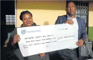  ?? Picture: SIKHO NTSHOBANE ?? START THEM YOUNG: Eastern Cape social developmen­t MEC Siphokazi Mani-Lusithi, left, is presented with a cheque of R55m by premier Oscar Mabuyane, which will be donated to 586 EDC centres across the O R Tambo district.