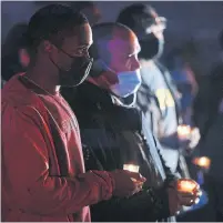  ?? STEVE RUSSELL TORONTO STAR ?? Lawrence Heights community worker Dejazmatch James, front, attends a memorial for shooting victim Shane Stanford.