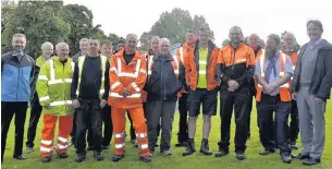  ??  ?? Gordon Mason, (front, fourth left in orange) the council’s longest serving employee, with workmates and (far right) council chief executive Dave Welsby