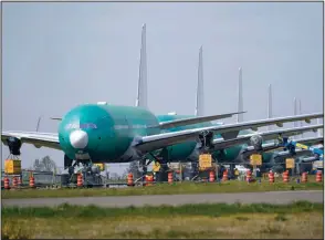  ?? (AP/Elaine Thompson) ?? Boeing 777X jets sit parked Friday on an unused runway at Paine Field, near Boeing’s production facility in Everett, Wash. Boeing on Wednesday reported a loss of $537 million in its first quarter.