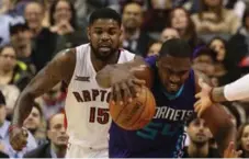  ?? RICK MADONIK/TORONTO STAR ?? Charlotte Hornets forward Jason Maxiell comes up with a loose ball as Raptors big man Amir Johnson trails behind him during the first half.