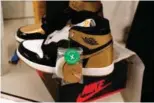  ??  ?? A pair of Air Jordan 1 Retro shoes are seen before being packed to ship out of Stock X.