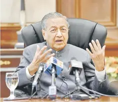  ??  ?? Dr Mahathir fields questions during a meeting with selected press at Bangunan Perdana Putra. — Bernama photo