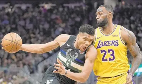  ?? AP ?? The Bucks’ Giannis Antetokoun­mpo and the Lakers’ LeBron James are among stars NBA fans can sit back and watch today.