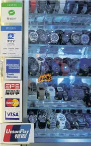  ??  ?? Labels of digital payment (from top) WeChat Pay, Alipay, American Express, Electronic Payment Services (EPS), MasterCard, Visa and UnionPay are displayed outside a store selling watches at a shopping mall in Hong Kong.
