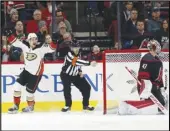  ?? Associated Press ?? OVERTIME WINNER Ducks center Sam Steel (34) celebrates his overtime goal against Carolina goaltender James Reimer (47)on Friday. Anaheim won 2-1.