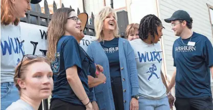  ?? EVERT NELSON/THE CAPITAL-JOURNAL ?? Washburn University president JuliAnn Mazachek laughs Thursday with student move-in crew members at The Villages. Mazachek went to the various residences around campus to talk with students and staff for her first move-in day in as president.