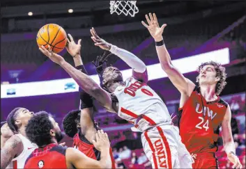  ?? L.E. Baskow Las Vegas Review-journal @Left_eye_image ?? UNLV forward Victor Iwuakor powers up for a basket as Incarnate Word forward Benjamin Griscti (24) tries to defend in the Rebels’ 88-63 home victory Saturday.