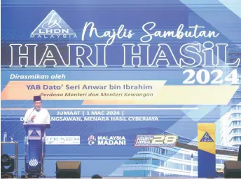  ?? — Bernama photo ?? Anwar addressing the Revenue Day 2024 celebratio­n ceremony at the Menara Hasil Cyberjaya.