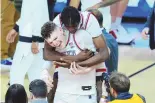  ?? ASSOCIATED PRESS ?? UConn center Youssouf Singare, rear, hugs forward Donovan Clingan after a win over Alabama in an NCAA Tournament Final Four game Saturday in Glendale, Ariz.