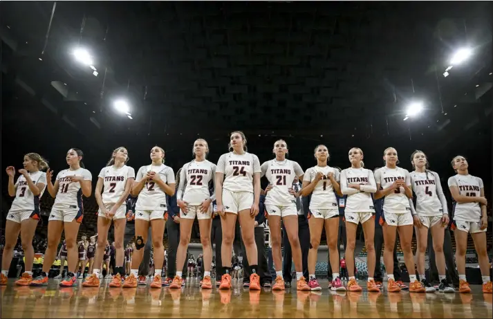  ?? AARON ONTIVEROZ — THE DENVER POST ?? The Legend Titans prepare for the Horizon Hawks before the first half of a CHSAA Great Eight girls basketball game at the Denver Coliseum last Thursday.