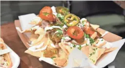  ?? BARRY GOSSAGE, NBAE/GETTY IMAGES ?? Carnitas Nachos from Hornitos Taco Bar.