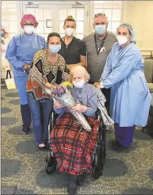  ?? Contribute­d photo / Whispering Pines ?? Pauline Romano, center, of East Haven, 101, who survived COVID-19 more than a century after surviving the Spanish Flu, with staff at Whispering Pines Rehabilita­tion & Nursing Center in East Haven.