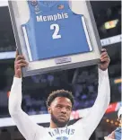  ?? JOE RONDONE/THE COMMERCIAL APPEAL ?? Memphis guard Alex Lomax is honored on senior day before a game against Houston at Fedexforum last March.