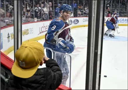  ?? AARON ONTIVEROZ — THE DENVER POST ?? Colorado forward Evan Rodrigues interacts with his son Grayson after giving him a puck per their pregame ritual before the first period against the Tampa Bay Lightning at Ball Arena on Tuesday.