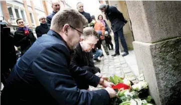  ?? — Reuters photo ?? Rasmussen (right) and Mayor of Copenhagen Frank Jensen lay flowers at the main synagoge in Copenhagen, in memory of Dan Uzan who was killed while working as a security guard at the synagoge last year.