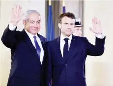  ?? — AFP photo ?? Netanyahu (left) and Macron wave prior to a working dinner at the Presidenti­al Elysee Palace in Paris.
