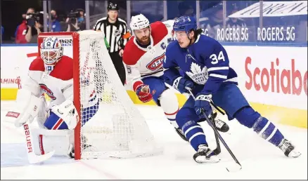  ??  ?? Toronto Maple Leafs forward Auston Matthews (34) scores on the wrap-a-round past Montreal Canadiens goaltender Jake Allen (34) as Canadiens defenseman Shea Weber (6) chases during the first period of an NHL hockey game on April 7, in Toronto. (AP)