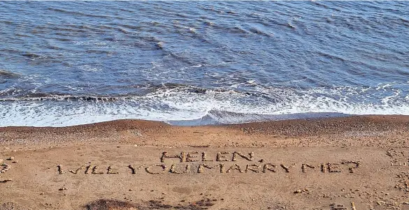  ?? ?? Steven Chell created this message on a beach at Hawthorn Dene – big enough to see from the cliff top – asking his partner Helen Richardson to marry him