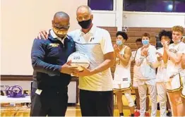  ?? NIKI DEHNER ?? Anthony Thomas (left), director of athletics at Francis Parker, congratula­tes Jim Tomey after the coach won his 500th career game on Tuesday.