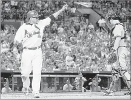  ?? JEFF ROBERSON/ASSOCIATED PRESS ?? The Cardinals’ Yadier Molina celebrates after scoring on Jon Jay’s double as Atlanta Braves catcher Brian McCann walks back to the plate during the second inning Friday in St. Louis.