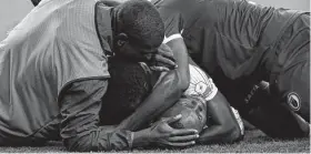  ??  ?? Haiti midfielder Wilde-Donald Guerrier, below, is mobbed by teammates after scoring the go-ahead goal against Canada during the second half of a Gold Cup quarterfin­als match Saturday.