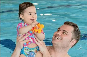  ??  ?? Lucas Forsman and daughter Riley Forsman take part in a swim class.