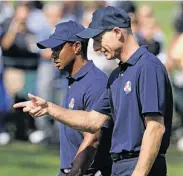  ?? Chris Carlson / Associated Press ?? Jim Furyk (right) needs to improve his Ryder Cup play, while Tiger Woods stepped up in 2006 and ’10.