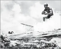  ?? Pictorial Parade/Getty Images ?? CAUGHT WAVE OF FAME Bruce Brown shoots footage for “The Endless Summer” in the 1960s. Distributo­rs initially treated the film as a long shot, but it became a classic.