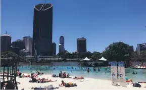  ??  ?? The artificial inner city beach by the banks of the Brisbane river