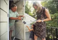  ?? Brian A. Pounds / Hearst Connecticu­t Media file photo ?? Rich Jacobs, of Fairfield, is handed campaign literature by Parker Pereira, then 3, daughter of 2018 candidate Caitlin Clarkson Pereira, during an afternoon of campaignin­g. In 2018, Clarkson Pereira was barred from using public election grants to pay for child care.