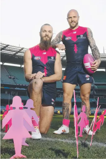  ?? Picture: GETTY IMAGES ?? Demons Max Gawn and Nathan Jones promote the Field of Women game against Sydney at the MCG on August 12, in support of Breast Cancer Network Australia.