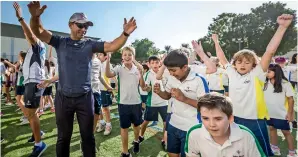  ?? — Photo by Neeraj Murali ?? Dr Abdulla Al Karam leads pupils in taking part in the fitness movement.