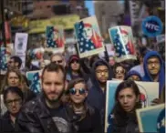  ?? THE ASSOCIATED PRESS ?? People carry posters during a rally in support of Muslim Americans and protest of President Donald Trump’s immigratio­n policies in Times Square in New York on Sunday