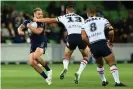  ?? Photograph: Quinn Rooney/Getty Images ?? Victor Radley slings a high arm across Cameron Munster at AAMI Park.