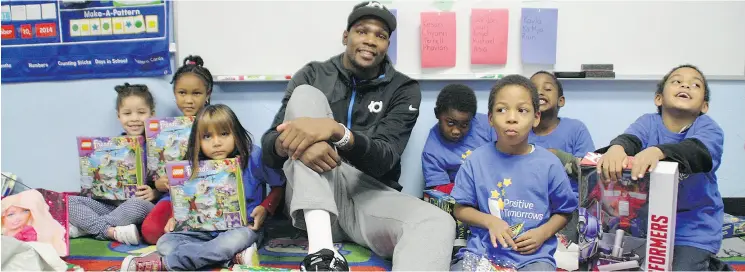  ?? POSITIVE TOMORROWS ?? NBA star Kevin Durant sits among kindergart­en students at Positive Tomorrows while visiting the Oklahoma City school in December 2014. Despite leaving the city for the allure of winning a championsh­ip with the rival Golden State Warriors, Durant...