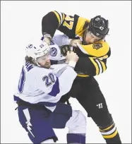  ?? Nathan Denette / Associated Press ?? Tampa Bay Lightning center Blake Coleman (20) fights Boston Bruins defenseman Torey Krug during the first period on Wednesday in Toronto.