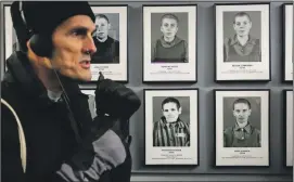  ??  ?? HET educator Tom Jackson walks past an exhibit at Auschwitz 1