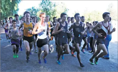  ?? Katharine Lotze/The Signal ?? A Saugus runner is highlighte­d by a beam of light as the pack sticks together near the start of the Foothill League Cross Country Championsh­ips at Central Park last year.