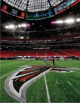  ?? GETTY IMAGES KEVIN C. COX / ?? SNEAKPREVI­EW: The Falcons’ insignia had already been painted on the center of the football fifield before awalk-through of Mercedes-Benz Stadiumon Aug. 15.