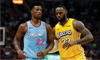  ?? Photograph: Michael Reaves/Getty Images ?? LeBron James of the LA Lakers guards Jimmy Butler of the Miami Heat during the second half of aDecember game.